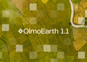 Página principal de OlmoEarth.allenai.org mostrando su plataforma de IA geoespacial para monitorización de humedales, manglares, incendios y océanos con datos de satélite